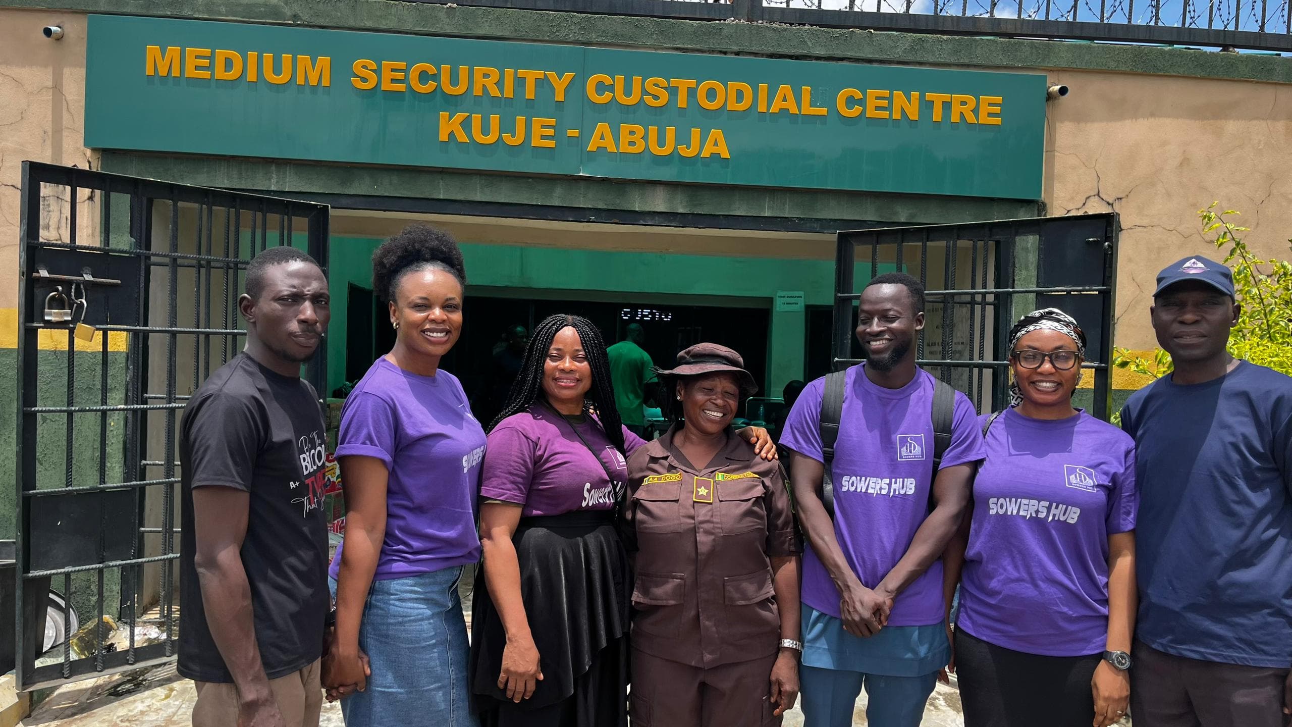 The SowersHub team with a correctional officer at the gate of Kuje Medium Security Custodial Centre, Abuja