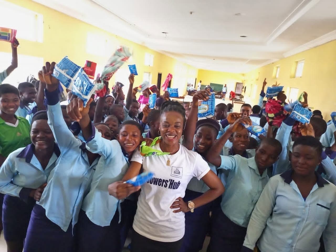 Schoolgirls celebrating with sanitary pads received through the Pad a Girl Child project